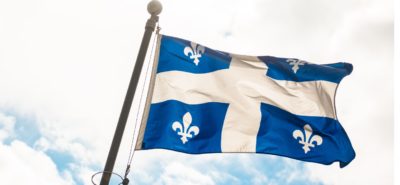 quebec flag against blue sky