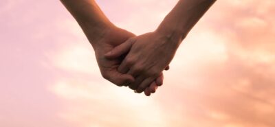 Cropped shot of an affectionate couple holding hands outdoors