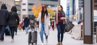 A multi-ethnic pair of female friends arriving to Canada
