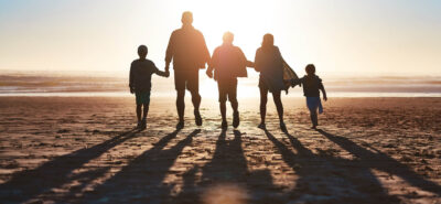 a family of 5 walking in the sand