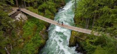 family crossing a bridge, in canada