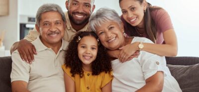 parents and grandparents smiling in a house